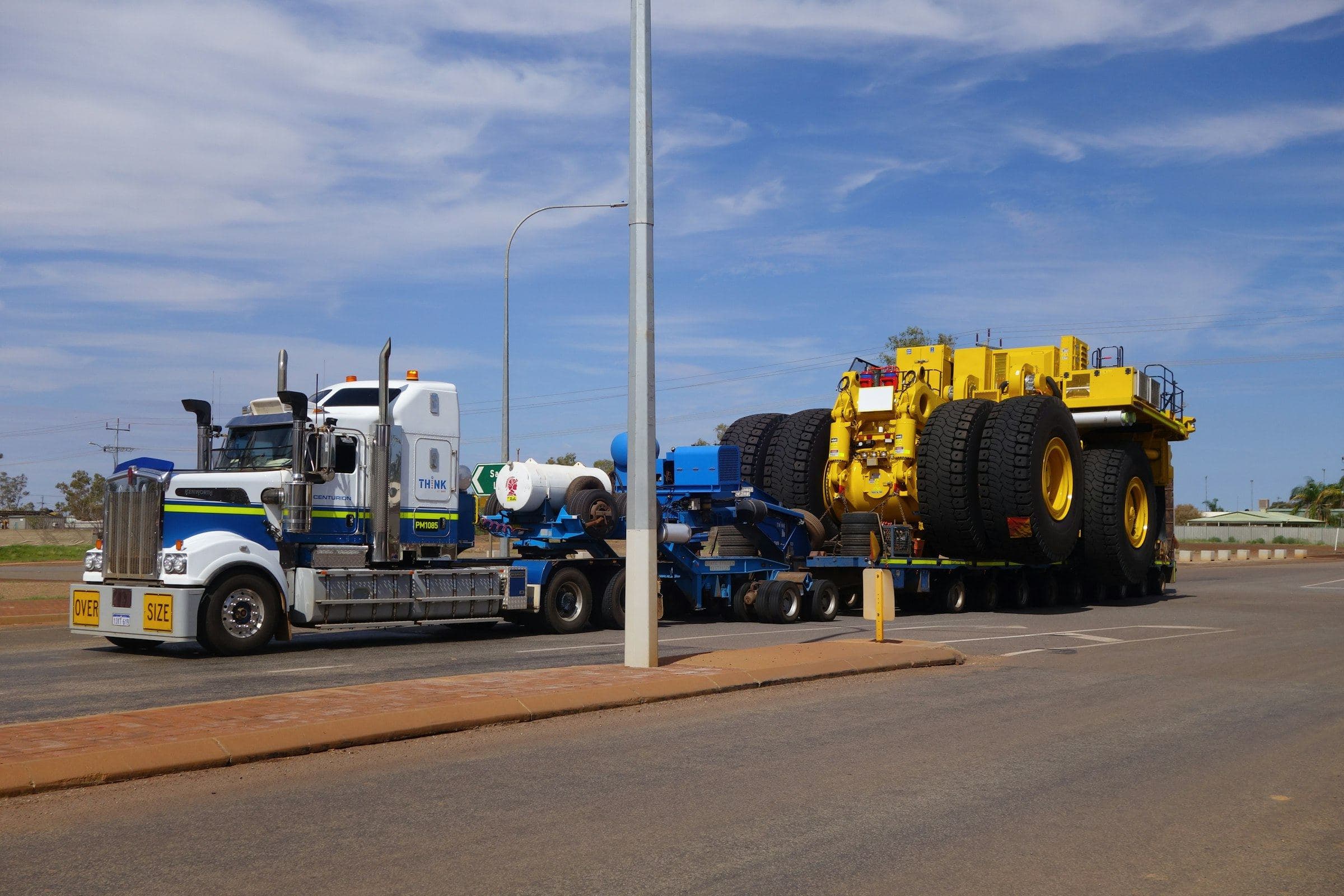 Heavy-haul truck transporting an oversized mining vehicle on a low-loader