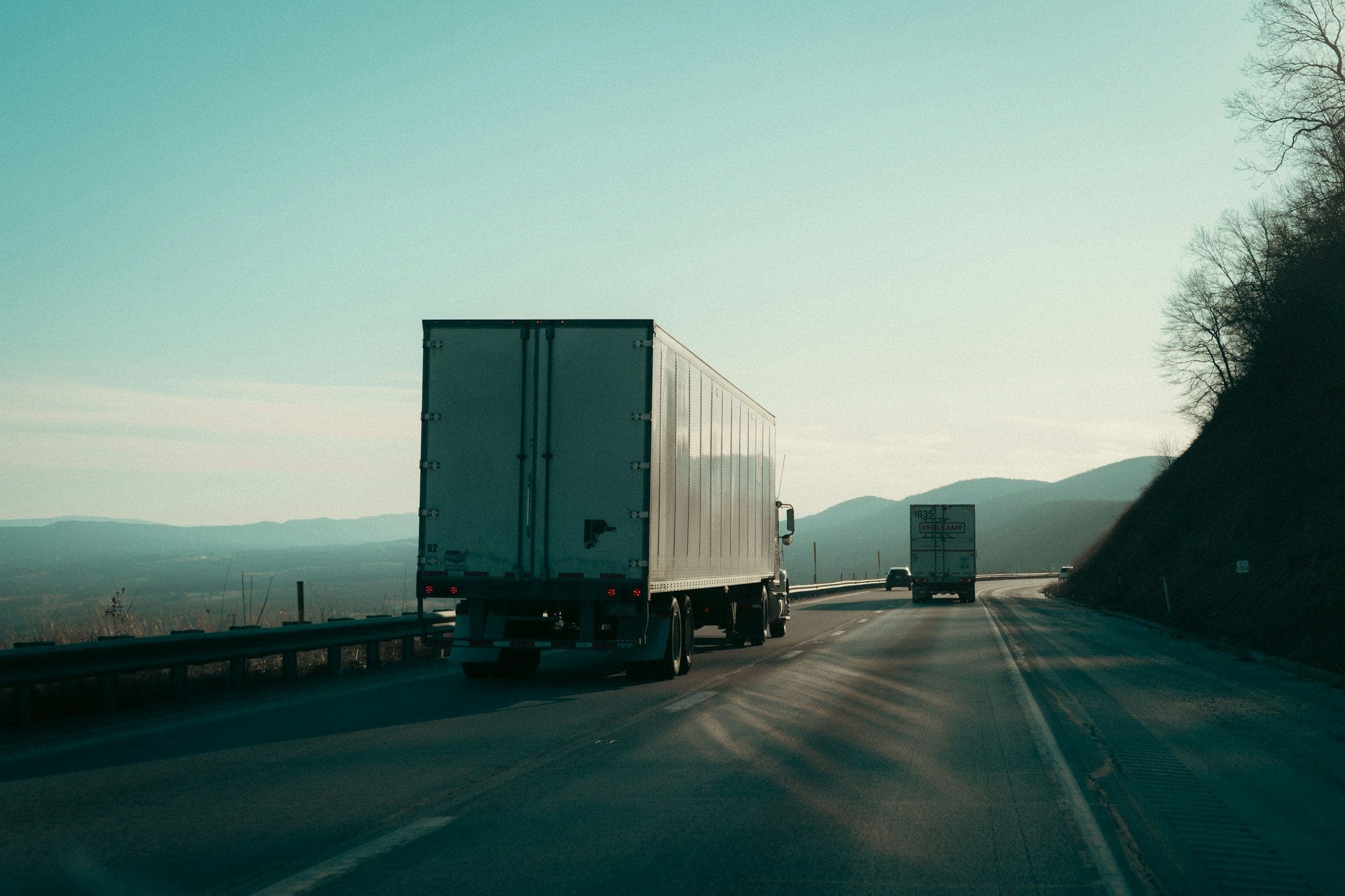 Trucks on a highway at dawn