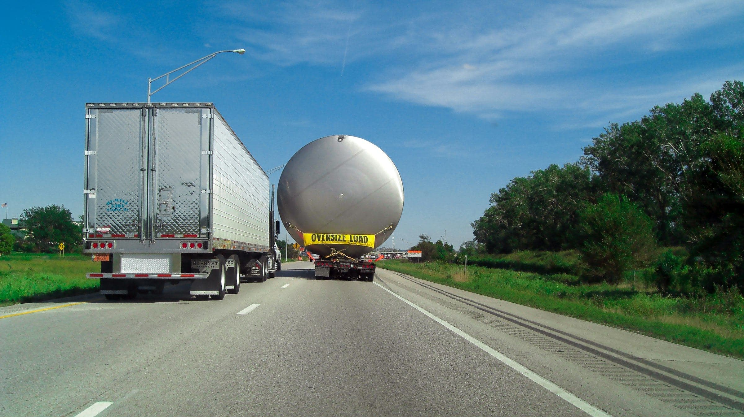 Oversized spherical tank on a low-loader on the highway
