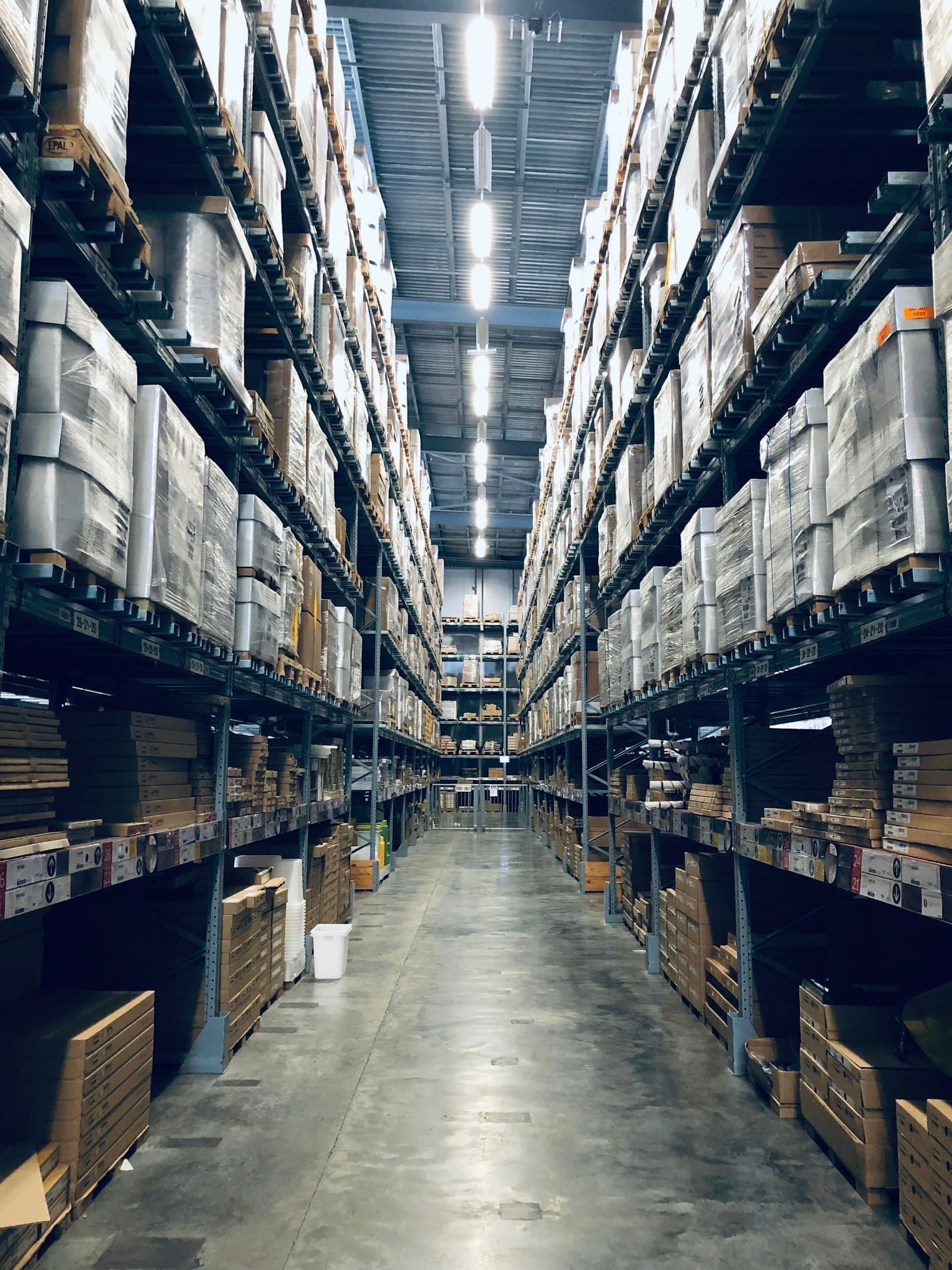 Long warehouse aisle with racked cargo